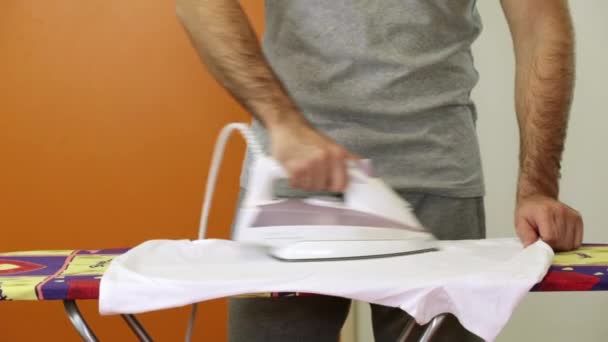 A man is ironing clothes with an iron, close-up. — Stock Video