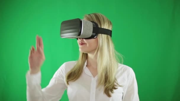 Beautiful woman in glasses of a virtual reality, does gestures by hand. — Stock Video