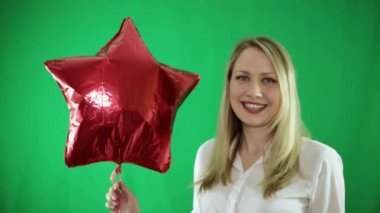 Yeşil bir arka plan üzerinde kırmızı hava balonu kadınla.