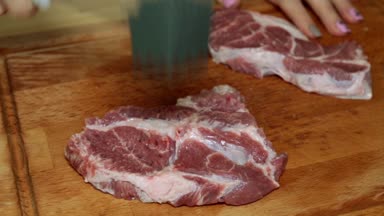 Bir kadın bir çekiç ile bir et atıyor yakın çekim.