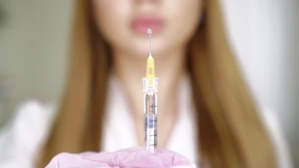 Vrouwelijke arts schoonheidsspecialiste houdt spuit met injectie. Close-up — Stockvideo