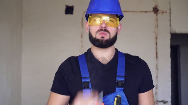 Un constructeur masculin fume une cigarette. Portrait d'un ouvrier fumeur en uniforme — Video