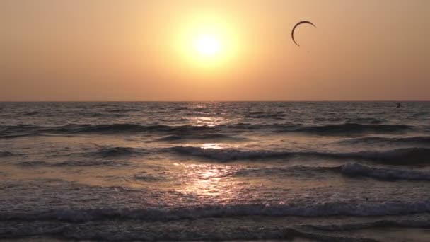 Прекрасный морской закат. Солнечный свет, песчаный пляж вечером. Кайт летит в небе — стоковое видео