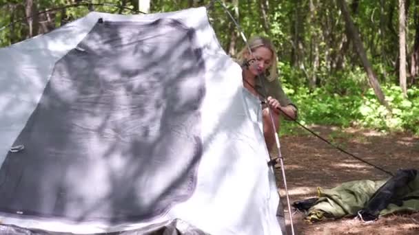 Mladá žena turista na kempování výlet stanoví stan v lese na přírodě — Stock video