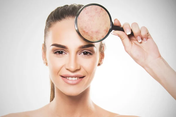 Beautiful girl with perfect skin holding magnifier close up face concept — Stock Photo, Image