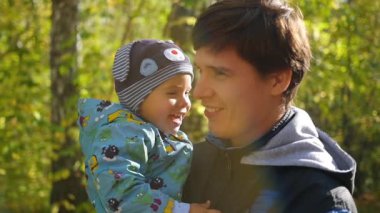 şefkatle sonbahar Park closeup bebekle oynayan genç Baba