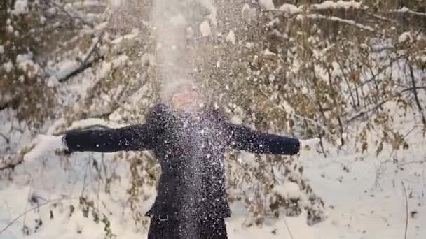 Girl throwing snow over himself and enjoys it in the winter park — Stock Video