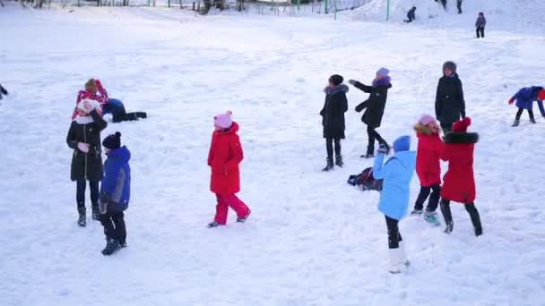 NOVOSIBIRSK, RUSSIE - 27 NOVEMBRE 2016 : groupe d'enfants qui s'amusent à jouer dehors en hiver — Video