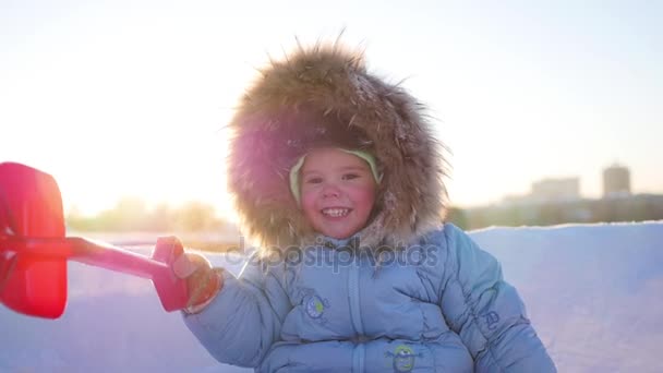 Щаслива дитина з веселощами сміється в зимовому парку в сонячний день. сніжний зимовий пейзаж. на відкритому повітрі — стокове відео