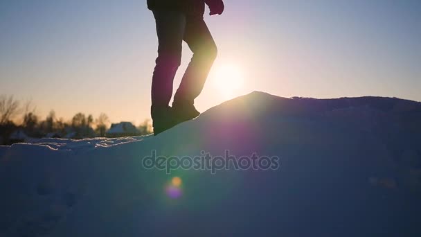 夕暮れ時の雪の斜面に行進の足。スローモーション。雪の冬の風景。アウトドア スポーツ — ストック動画