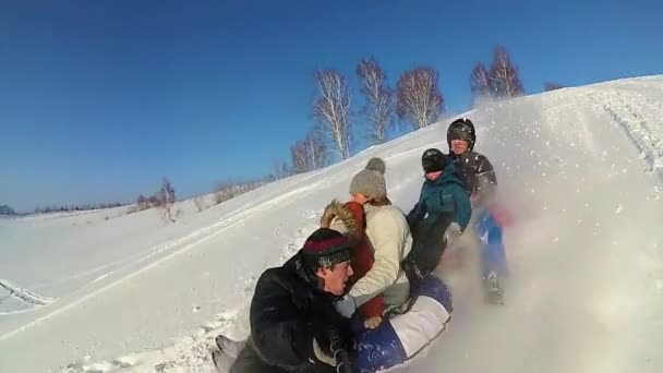 Felice famiglia cavalca e sorridente snowtube su strade innevate.rallentatore. neve paesaggio invernale. sport all'aria aperta — Video Stock