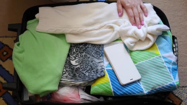 Chica pone cosas en la maleta para viajar en primer plano — Vídeos de Stock