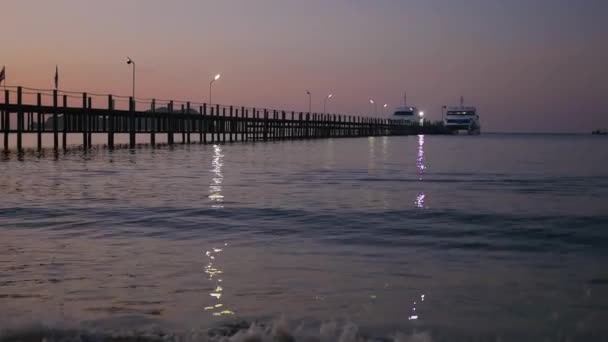 Surf al amanecer cerca del muelle — Vídeo de stock