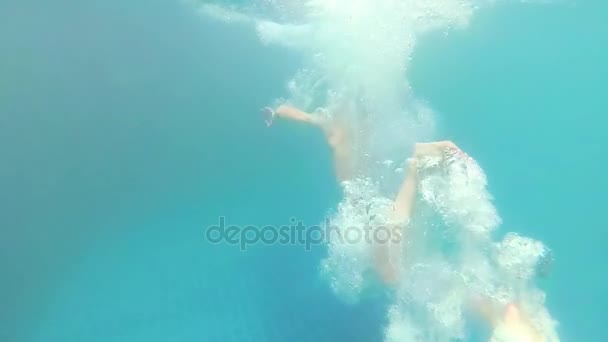 Happy child swims with enjoyment under the water in the pool — Stock Video