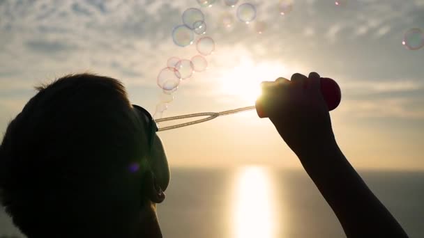 The boy is making soap bubbles. Closeup. Panoramic view — Stock Video