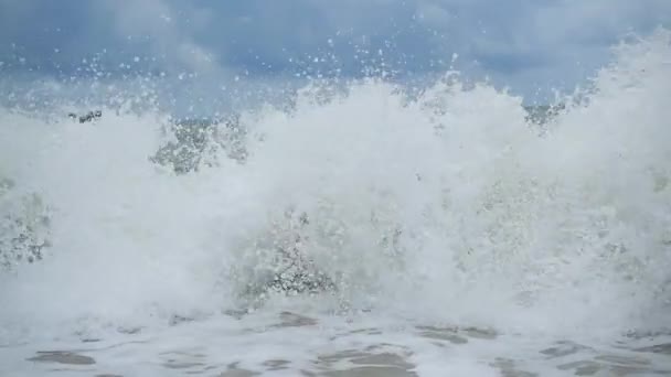 Il bambino si trova sulla spiaggia ed è bagnato da grandi onde marine — Video Stock