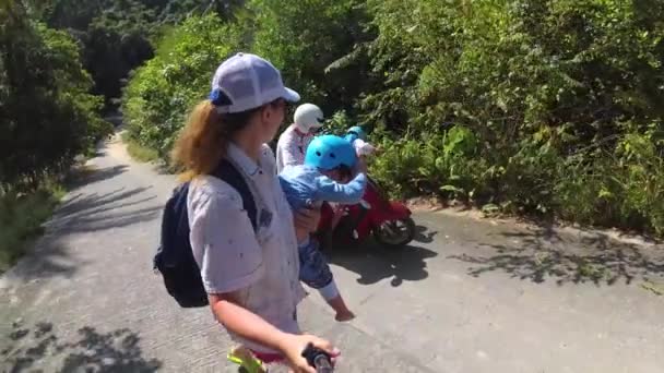 Motobike üzerinde seyahat iki çocuklu aile. Parlak güneşli bir günde. Samui, Tayland — Stok video