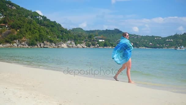 Молодая девушка с парео на берегу пляжа. Тропический остров, теплый летний ветер — стоковое видео