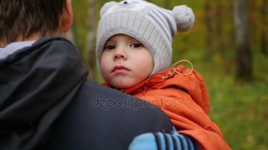 Genç bir baba çocuğunu onun kollarında tutar. Hassasiyet ve sevgili babam kucaklama.