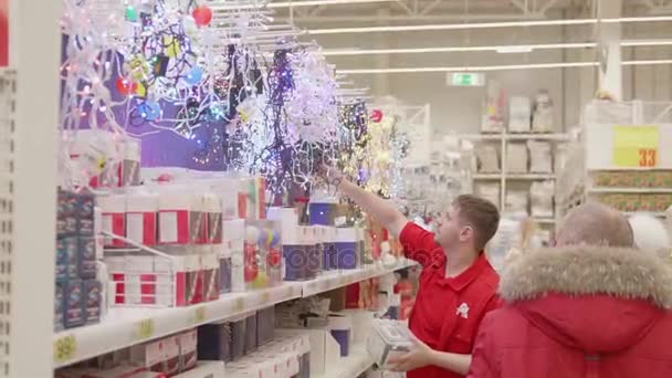 NOVOSIBIRSK, RUSIA - 25 de noviembre de 2017: Venta de juguetes y árboles de Navidad hasta Navidad. La gente en el supermercado está de compras antes del año nuevo. Regalos de Navidad para seres queridos . — Vídeos de Stock