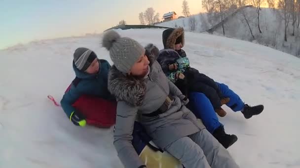 Szczęśliwa rodzina jeździ i uśmiechający się airboardowej na snowy roads.slow ruchu. Snow Zima Krajobraz. Sport na świeżym powietrzu — Wideo stockowe