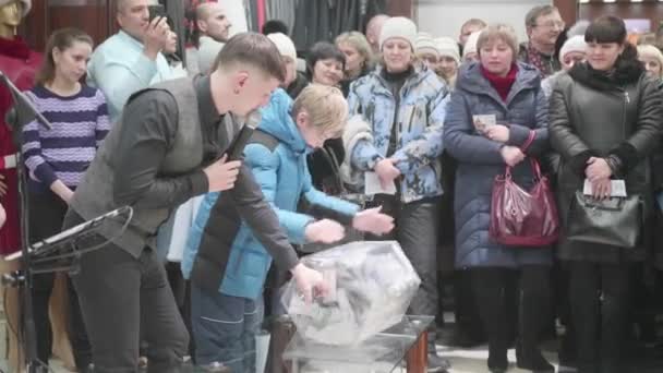 Одесса, Російська Федерація - 2 лютого 2018: Лотерея в торговому центрі. Хлопчик спинами барабан з лотерей — стокове відео