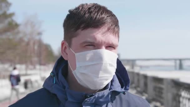 Een man met een beschermend masker op straat. Preventie en bescherming van de gezondheid en de veiligheid van het leven. — Stockvideo