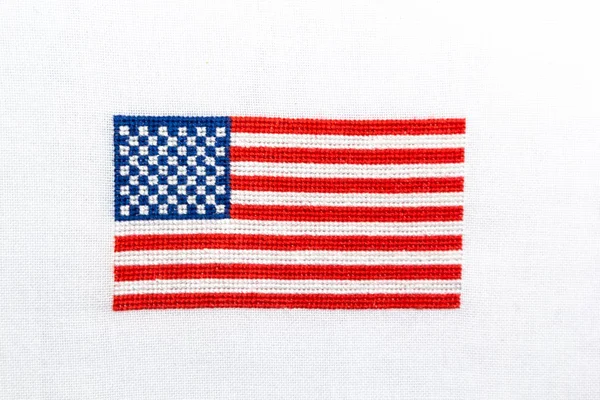 US flag embroidered on the white fabric. — Stock Photo, Image