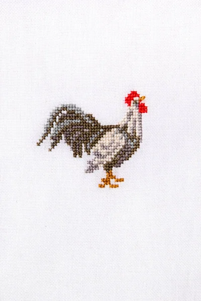 Symbol 2017 embroidered rooster on the white fabric. — Stock Photo, Image