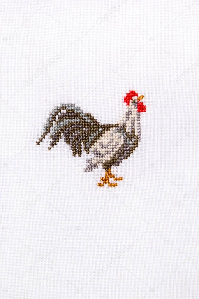 Symbol 2017 embroidered rooster on the white fabric.