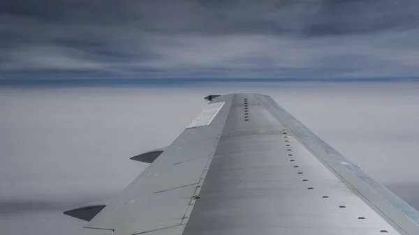 Wing of airplane above the clouds — Stock Photo, Image