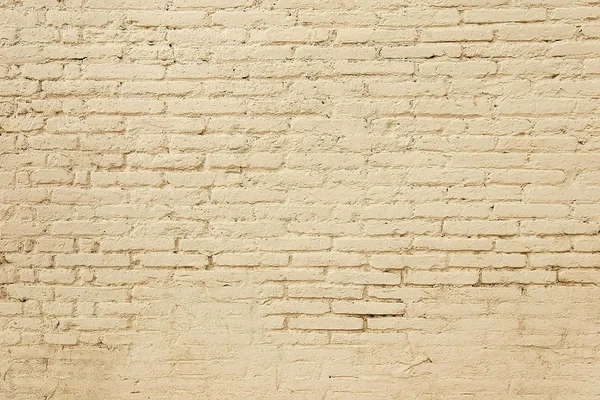 Old brick wall with beige paint background texture