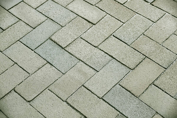 Grey stone pavement background texture close up