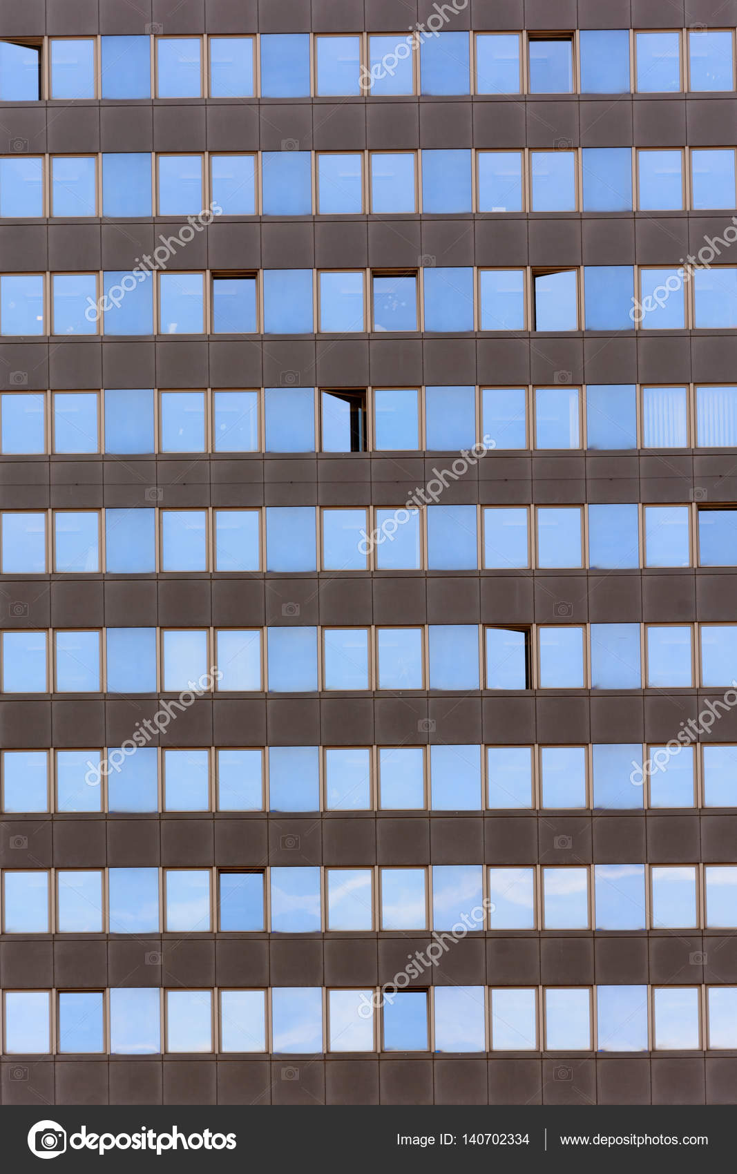 Texture windows on high-rise building. Reflection of the sky from the  windows. The windows of an office building. Stock Photo by ©karelpesorna  140702334
