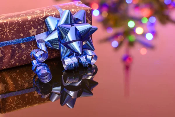 Christmas Gift Wrapped Purple Wrapping Paper Bound Blue Ribbon Ornament Stock Picture