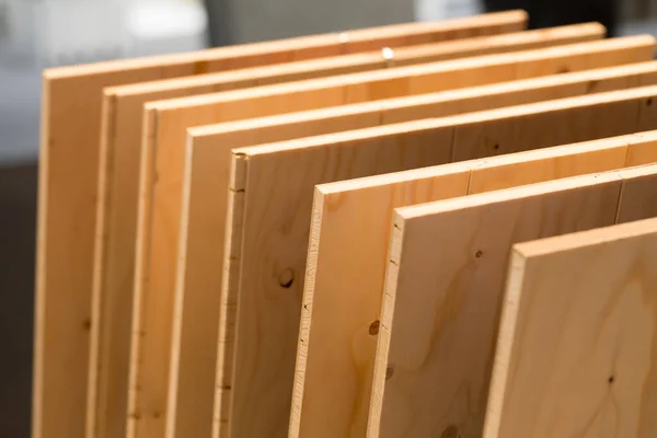 Light wooden samples on building shop showcase close up.