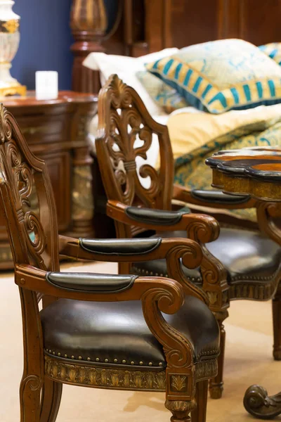 Old-fashion wooden royal style chair close up.