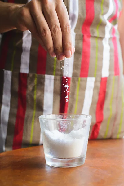 Chef pour salt in a glass — Stock Photo, Image