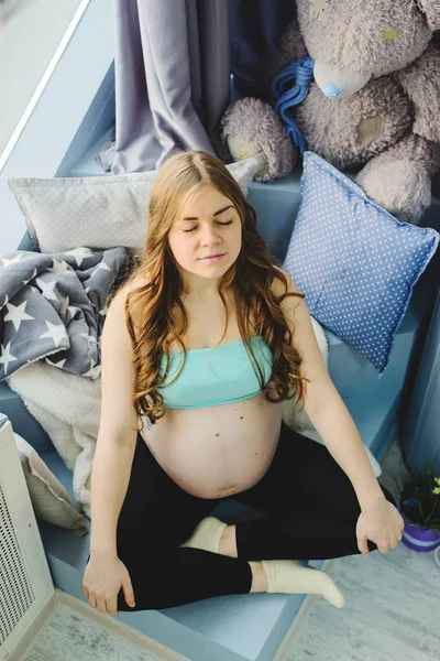 Chica embarazada sentada —  Fotos de Stock
