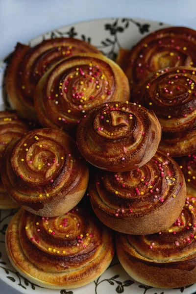 sweet baked rolls buns with cinnamon and colorful sprinkle