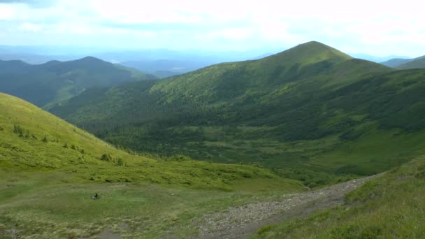 Shadows of clouds quickly glide along the mountain slopes. — Stock Video