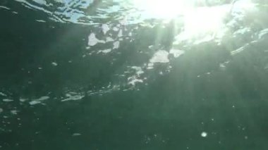 Deniz yüzey oyuncak su sütunu içinde geçen güneş ışınlarının.