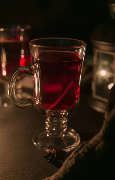 Mulled wine in glass mugs with candles