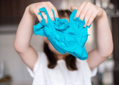Çocuk elleri renkli kille oynuyor. Ev yapımı plastik. Plastiksin. Hamur oyna. Kil kalıbı yapan kız. Ev yapımı kil.