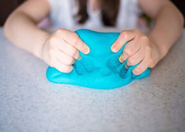 Çocuk elleri renkli kille oynuyor. Ev yapımı plastik. Plastiksin. Hamur oyna. Kil kalıbı yapan kız. Ev yapımı kil.