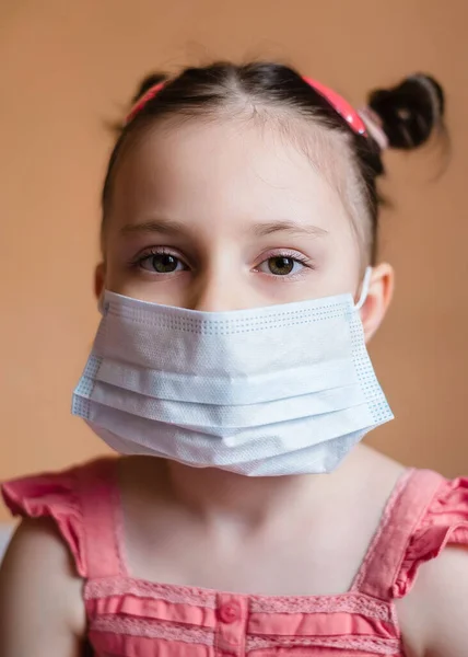 Kid girl wearing protection face mask against coronavirus. Kid in mask