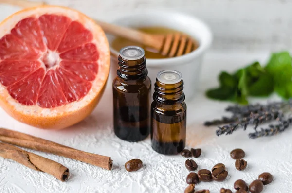 Ingredients for homemade cosmetics: essential oil, grapefruit, mint, tea tree oil, coffee beans, cinnamon sticks, lavander. Natural aromatization at home. Organic scrub, maskand body cream