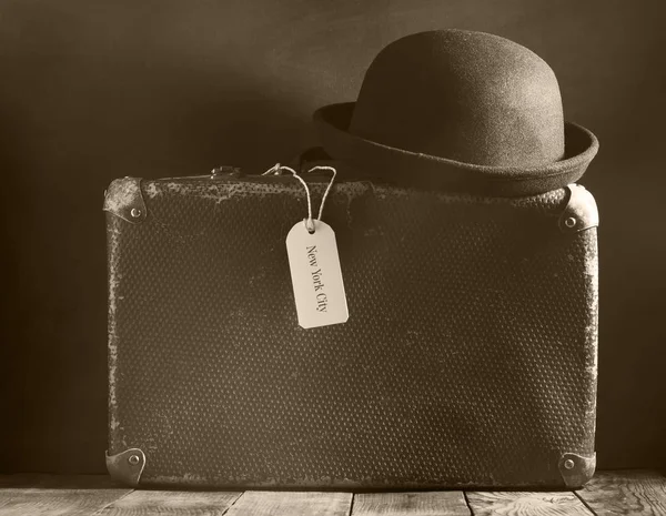 stock image Old vintage suitcase on a wooden floor.Sepia toning