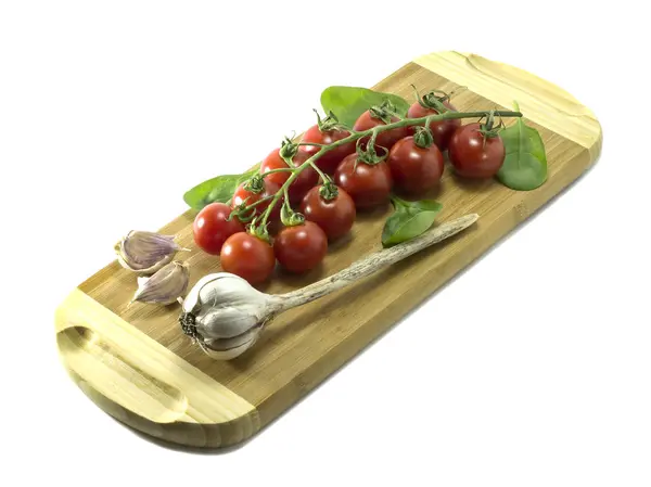 Mature Cherry tomatoes on a cutting board on a white background. — Stock Photo, Image