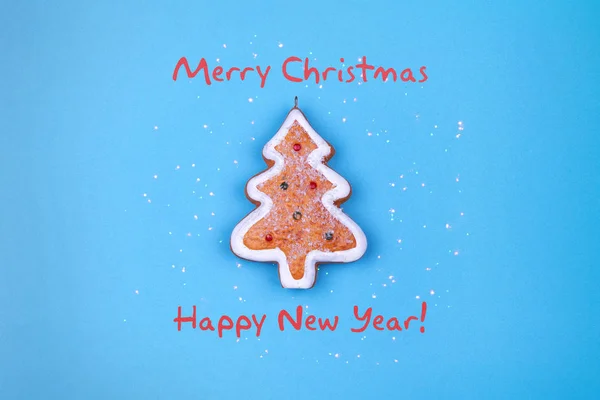 Happy New Year and Merry Christmas. Christmas gingerbread on a blue background. Greeting card. — ストック写真